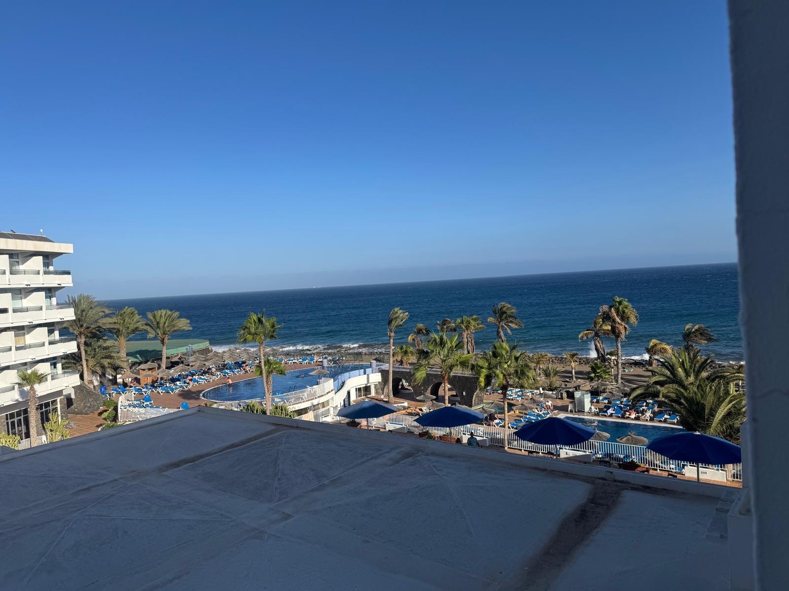 View of the sea and pool from the hotel balcony
